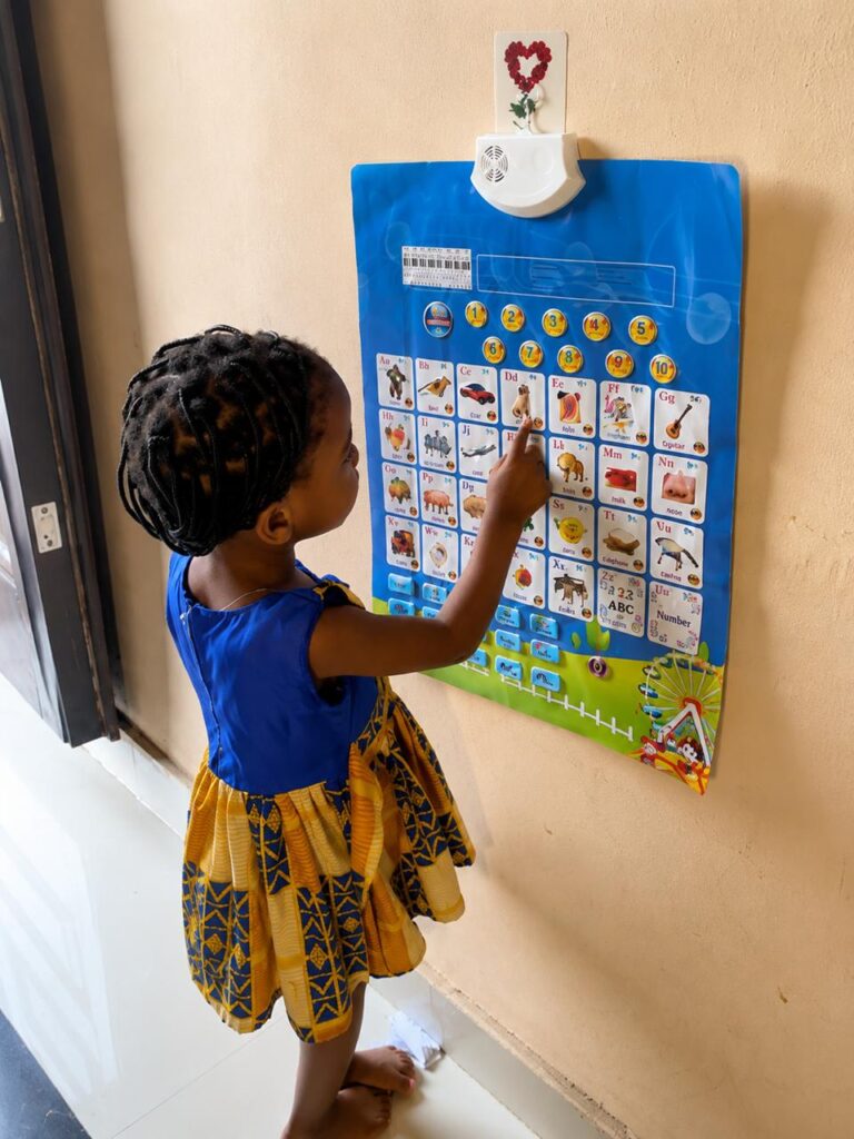 Little girl using Epicckids talking chart